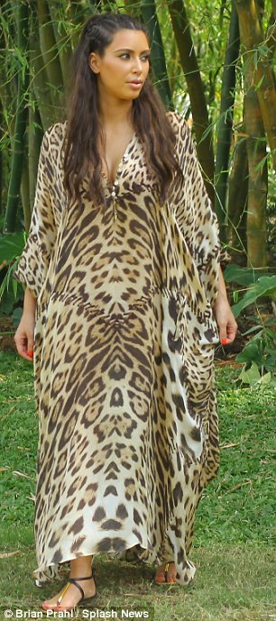 Kim was also seen in a leopard print kaftan and had huge frizzy hair
