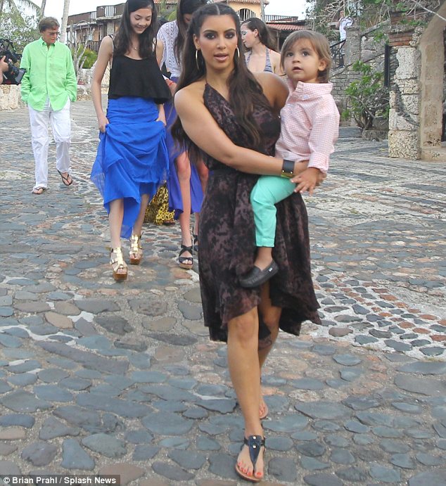 Kim who has recently started dating Kanye West, was seen carrying her nephew as the family stepped out for one evening