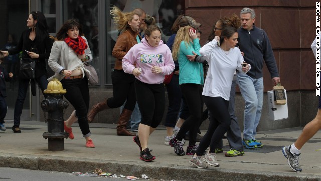 People run down Exeter Street after the blasts.