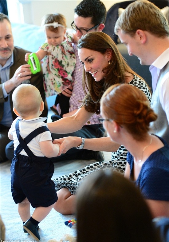 A few of the other first-time parents gathered around Kate as she lifted her son to his feet. The playgroup is made up of ten families whose children were born within two weeks of George's July 22 birthday